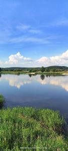 a large lake with clouds in the water at B&B Stare Łysogórki in Stare Łysogórki