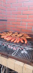 a bunch of hot dogs and other food on a grill at B&B Stare Łysogórki in Stare Łysogórki