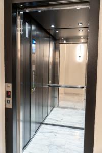 an elevator in a building with a glass door at Piscul Negru Hotel - Transfagarasan in Cumpăna