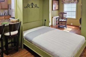 a bedroom with a bed and a table and chairs at Hidden Creek Cabin in Franklin +17 photos