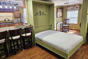 a bedroom with a bed and a bar in a kitchen at Hidden Creek Cabin in Franklin