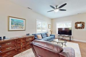 a living room with a couch and a flat screen tv at Cool Springs Manor in Asheville