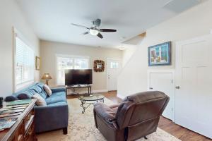 a living room with a blue couch and a tv at Cool Springs Manor in Asheville