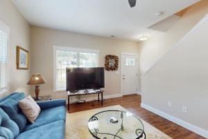a living room with a blue couch and a tv at Cool Springs Manor in Asheville