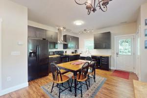 a kitchen with a table and chairs and a refrigerator at Cool Springs Manor in Asheville +22 photos