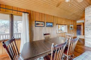 a dining room with a wooden table and chairs at Morris Villa Upper in Lake Junaluska