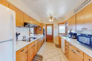a large kitchen with wooden cabinets and white counter tops at Morris Villa Upper in Lake Junaluska