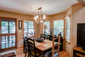 a dining room with a table and chairs and a television at Oasis In the Mountains in Murphy