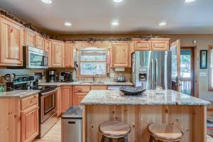 a kitchen with wooden cabinets and a refrigerator at Oasis In the Mountains in Murphy