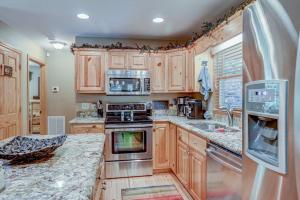 a kitchen with wooden cabinets and a stove top oven at Oasis In the Mountains in Murphy +52 photos
