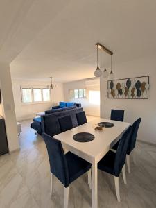 a dining room with a white table and chairs at Holiday Home Norr in Bihać