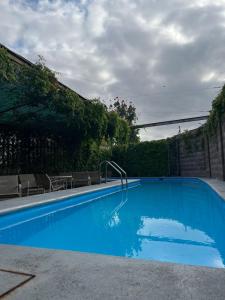 a large blue swimming pool with chairs in a yard at Hotel Maioris Bellavista in Culiacán +18 photos
