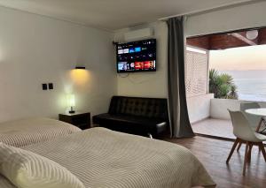 a bedroom with two beds and a view of the ocean at Hotel Camino del Alto Reñaca in Viña del Mar