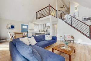 a living room with a blue couch and a staircase at Wildwood in Fletcher