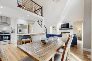 a kitchen and living room with a wooden dining table at Wildwood in Fletcher +17 photos