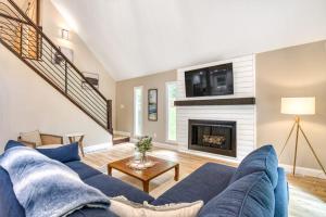 a living room with a blue couch and a fireplace at Wildwood in Fletcher
