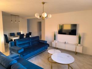 a living room with a blue couch and a table at Holiday Home Norr in Bihać