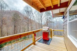 a deck with a red fire hydrant on it at Bryson Chalet in Bryson City