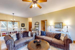 a living room with two couches and a ceiling fan at Link Vacation in Whittier