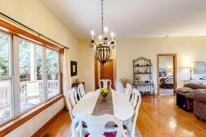 a dining room with a white table and chairs at Link Vacation in Whittier +34 photos