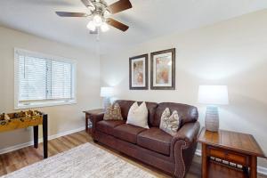 a living room with a brown leather couch and a table at Rumbling Bald Resort Unit 2004 in Lake Lure