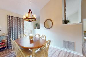 a dining room with a wooden table and chairs at Rumbling Bald Resort Unit 2004 in Lake Lure +32 photos