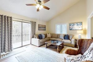 a living room with a couch and a ceiling fan at Rumbling Bald Resort Unit 2004 in Lake Lure
