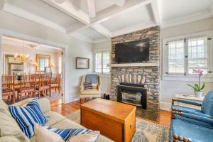 a living room with a fireplace and a tv at Chapel Side in Lake Junaluska