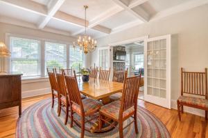 a dining room with a wooden table and chairs at Chapel Side in Lake Junaluska