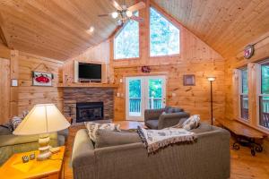 a living room with two couches and a fireplace at Wunderland Cabin in Lake Lure