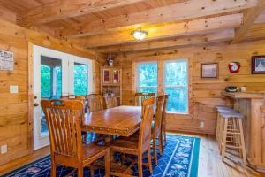 a dining room with a wooden table and chairs at Wunderland Cabin in Lake Lure
