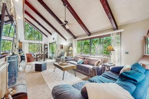 a living room with a blue couch and a table at Yopp's Treehouse in Lake Lure