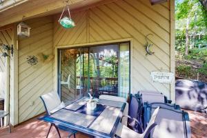 a patio with a table and chairs on a porch at Yopp's Treehouse in Lake Lure