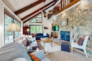 a living room with a large stone wall at Yopp's Treehouse in Lake Lure