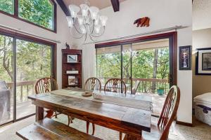 a dining room with a wooden table and chairs at Yopp's Treehouse in Lake Lure +17 photos