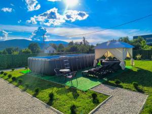 a gazebo with two chairs and a table in a yard at Holiday Home Norr in Bihać
