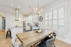 a kitchen and dining room with a wooden table and chairs at Downtown Delight in Brevard