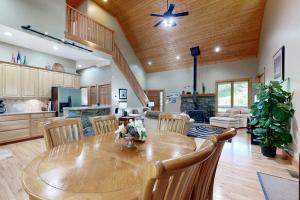 a kitchen and dining room with a wooden table and chairs at Rhymer Haven in Juno