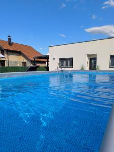 a swimming pool in front of a house at Holiday Home Norr in Bihać