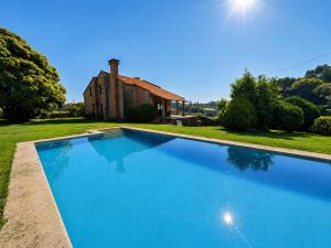 a large swimming pool in front of a house at Vila Xocas in Baiona