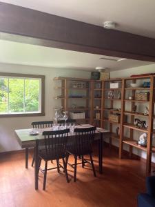 a dining room with a table with wine glasses on it at Cabin by the Creek in Roberts Creek