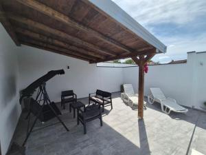 a photograph of a patio with chairs and a camera at Holiday Home Dalia with Private Pool in Blagaj