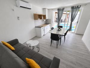 a living room and kitchen with a couch and a table at Holiday Home Dalia with Private Pool in Blagaj