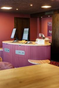 a counter with two computers on top of it at b-smart hotel Widnau in Widnau