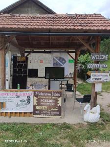 a pavilion with two swans and a sign in front at Kamp Suad in Zaglavica