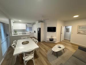 a kitchen and living room with a table and chairs at Clearwater Noosa Resort in Noosaville
