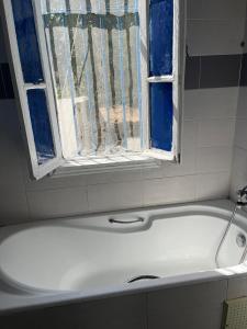 a bath tub in a bathroom with a window at 3 bedroom Villa with garden in Ez Zahra +33 photos