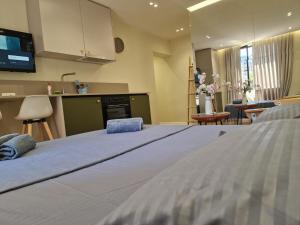 a bedroom with a large bed and a kitchen at Central Bazaar with Parking in Tirana