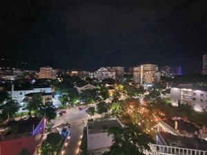 a view of a city at night with lights at Central Bazaar with Parking in Tirana