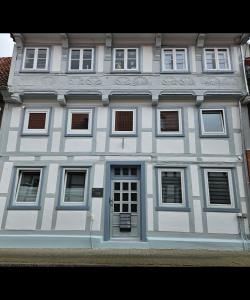 a white building with windows and a door at Asanov Retreat in Northeim
